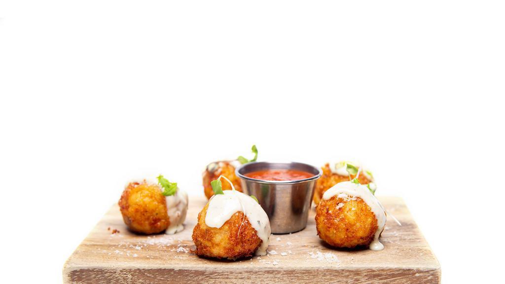 Mac & Cheese Bites · Creamy five cheese mac and cheese bites with pieces of bacon and finished with Maytag aioli.