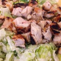 Chicken Caesar Salad · Crisp romaine lettuce tossed with Caesar dressing and seasoned croutons and parmesan cheese....