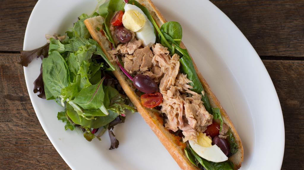 Mediterranean Tuna · Organic egg, mesclun greens, tomatoes, black olives, harissa spread on a french baguette.