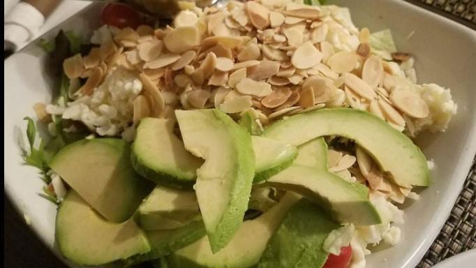 Avocado Salad · Spring mixed greens and chopped iceberg lettuce, shredded mozzarella, avocado, toasted almonds and tomato with a balsamic vinaigrette on the side.