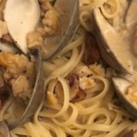 Linguine With Clam Sauce · Authentic  clam sauce is sauteed in a garlic and extra virgin olive oil brodino in our red m...