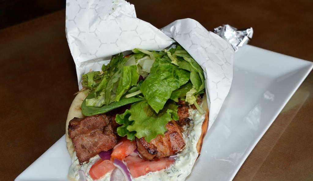 Pork Souvlaki · Served in a warm pita with lettuce, tomatoes, red onions, and tzatziki sauce.