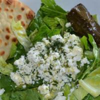 Romaine Salad · Romaine, scallions, dill, feta, grape leaf, and lemon vinaigrette.