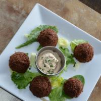 Falafel · Gluten-Free. Ground chickpeas with fresh herbs and spices. Served with tahini.