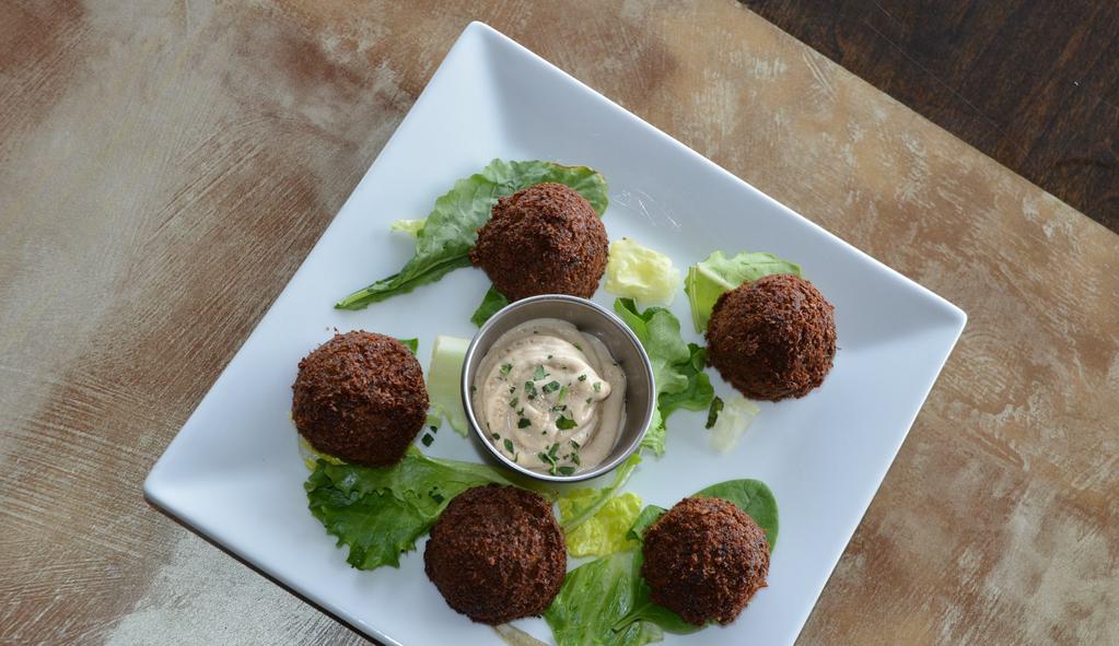Falafel · Gluten-Free. Ground chickpeas with fresh herbs and spices. Served with tahini.