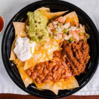 Nachos Supreme · Choice of meat, regular chips, topped with refried beans, black olives, pico de gallo, and n...