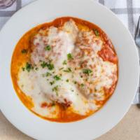 Chicken Parmigiana · Chicken cutlet with tomato sauce and Mozzarella.