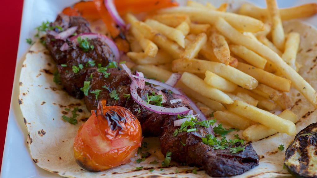 Sevan Steak  · Premium beef in a special house marinade served with grilled vegetables, rice and pita bread.