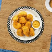 Chicken Nuggets 12 Pcs · Bite sized nuggets of chicken breaded and fried until golden brown. Served with your choice ...
