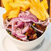 Ceviche De Chicharron · Pork crackling brittles marinated in citrus fruits and corn. Served with plantains chips.