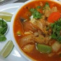Sopa De Mondongo · Cows feet, belly and vegetables topped with onion and cilantro served with rice.