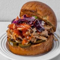 Rj Pulled Chicken On Brioche · Pulled Chicken with Pickled Jalapeños, Tangy Slaw, Crispy Onions & Boom Boom Sauce served on...