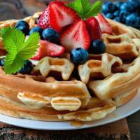 Waffle With Cream & Fresh Fruit · Classic Buttery waffle, served hot off the press. Topped with whipped cream, and an assortme...