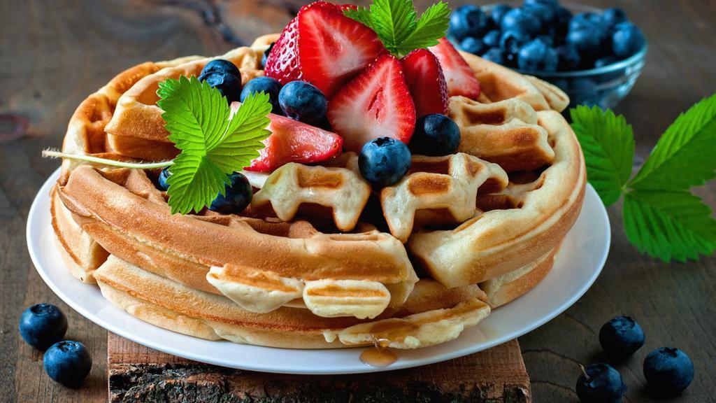Waffle With Cream & Fresh Fruit · Classic Buttery waffle, served hot off the press. Topped with whipped cream, and an assortment of fresh, sliced fruit.