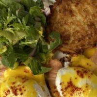 Eggs Benedict · 2 poached eggs, Canadian bacon on a toasted English muffin, Hollandaise sauce, mixed fruit, ...