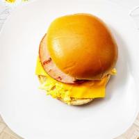Ham, Egg, And Cheese Sandwich · Ham, scrambled egg, and cheddar cheese served on a bread