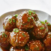 Vegan & Gf Meatballs · Six meatballs with a side of marinara sauce.