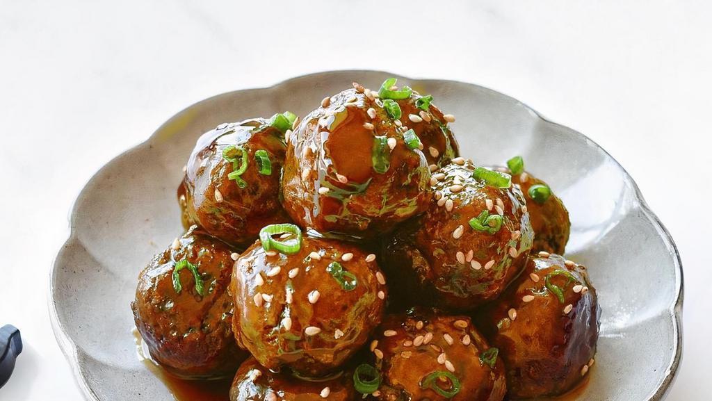 Vegan & Gf Meatballs · Six meatballs with a side of marinara sauce.