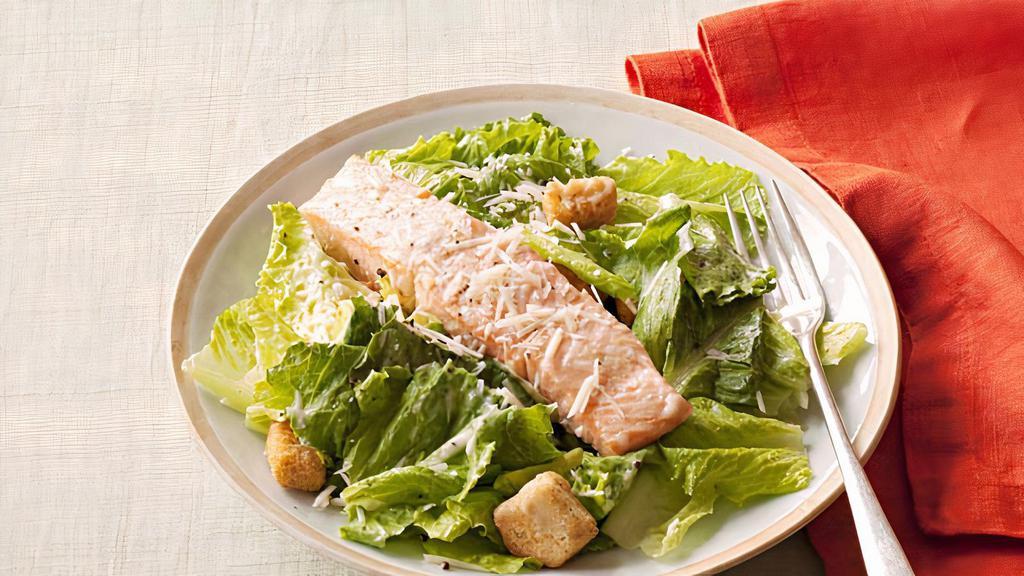 Salmon Caesar Salad · Gluten-free croutons , parmesan cheese and Caesar dressing .