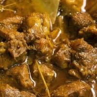Curried Goat · Served with choice of rice and salad.