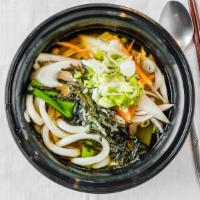 Udon · Thick flour noodles in mild, clear soup with mixed vegetables, scallions and pieces of nori.