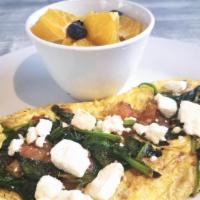 Greek Omelette · Three eggs, spinach, tomato, feta cheese with a bagel on the side.