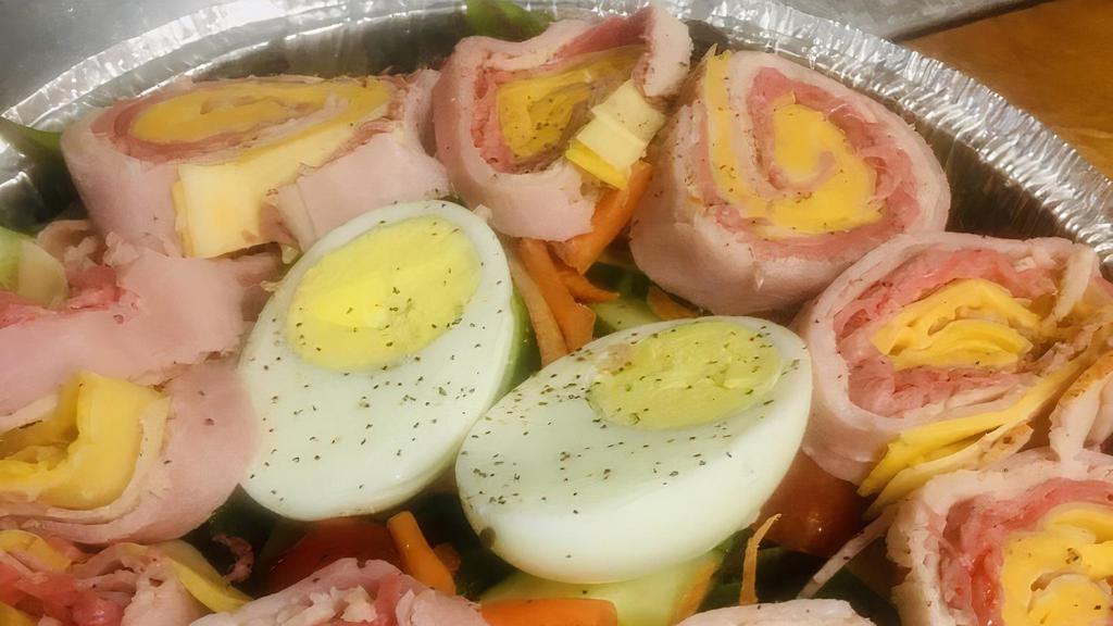 Chef Salad · Tossed lettuce, hard-boiled egg, ham, turkey, chicken, tomatoes, cucumbers and cheese.