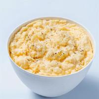 Buttered Grits · Carolina stone-ground grits whipped to a rich consistency with a hint of parmesan cheese.