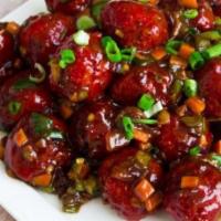 Veg Manchurian · Vegan. Minced veg balls tossed in a soy based manchurian sauce.