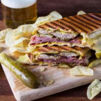 Cuban · Sliced porchetta, ham, swiss cheese, pickle and mustard.