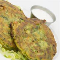 Pan Fried Zucchini Patties · A delicious combination of tender zucchini and fresh herbs and spices served with our specia...