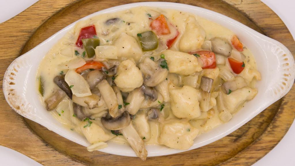 Creamy Chicken · Tender pieces of breast sautéed with fresh onions, red and green bell peppers, mushrooms and touch of mozarella, seasoned with herbs and spices in cream sauce - served with rice.