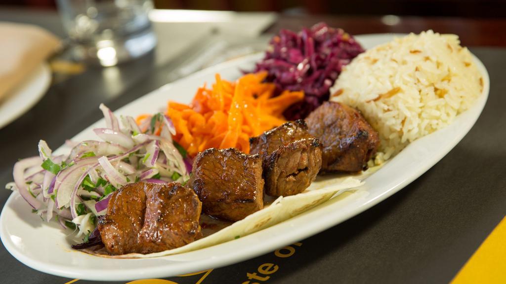 Lunch Lamb Shish Kebab · Tender cubes of lamb marinated in our chef's unique seasonings and char-grilled to perfection on skewers.  Served with jasmine rice, pickled red cabbage, shreded carrots and sliced onions