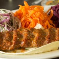 Lunch Lamb Adana · A mouth-watering creation of freshly hand chopped lamb flavored with red bell peppers, light...