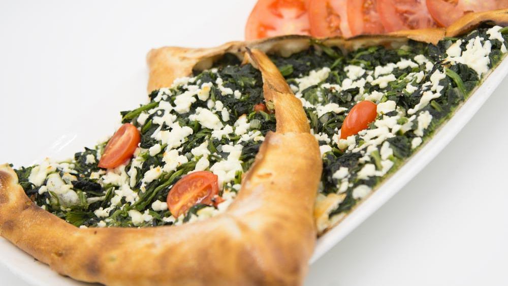 Spinach Pide  · A crispy golden crust topped with sauteed spinach, feta cheese, bell pepper and tomato.