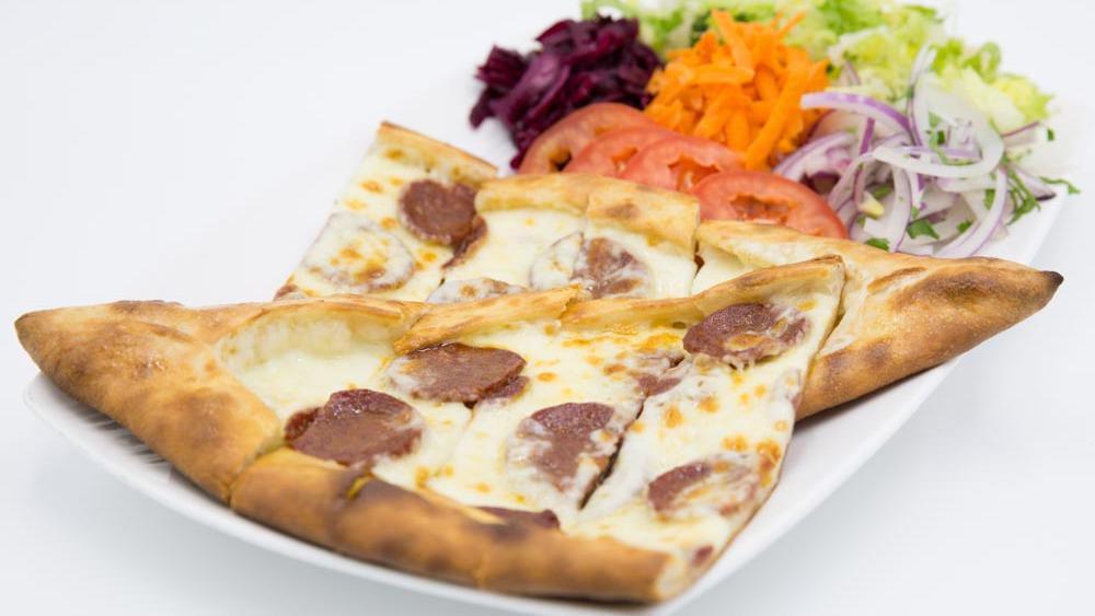 Soujuk Pide (Sucuklu Pide) · A thin crust topped with Turkish soujuk, (beef pepperoni) mozzarella cheese, bell pepper and tomato.