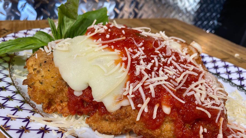 Chicken Parmigiana  · Breaded chicken, mozzarella cheese, & tomato sauce