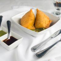 Samosa · Two pieces of vegetables, mashed potatoes stuff, and deep-fried.