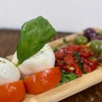 Tomato & Mozzarella · Vine tomatoes and burrata mozzarella served with olives and roasted red peppers.