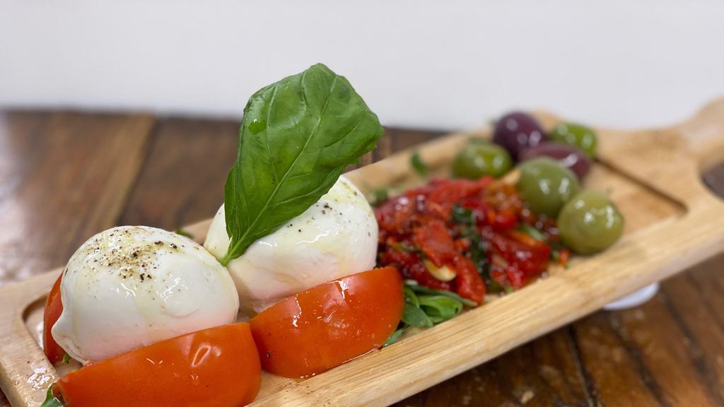 Tomato & Mozzarella · Vine tomatoes and burrata mozzarella served with olives and roasted red peppers.