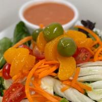 Fennel Salad · Sliced crisp fennel served over baby greens, topped with tomatoes, oranges, and olives. Serv...
