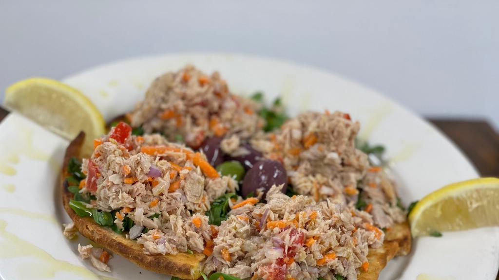 Sicilian Tuna Salad · Imported Sicilian tuna over brick oven flatbread, topped with tomatoes, olives, carrots, and arugula, drizzled with extra virgin olive oil and lemon.