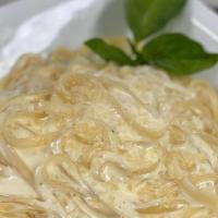 Fettuccine Alfredo · Fettuccine served with alfredo sauce made with cream butter and parmesan cheese.