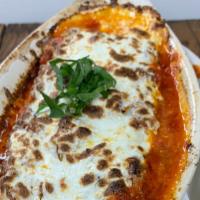 Lasagna · Lasagna layered with bolognese sauce, bechamel, and fresh mozzarella.