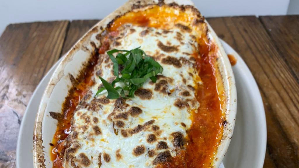 Lasagna · Lasagna layered with bolognese sauce, bechamel, and fresh mozzarella.