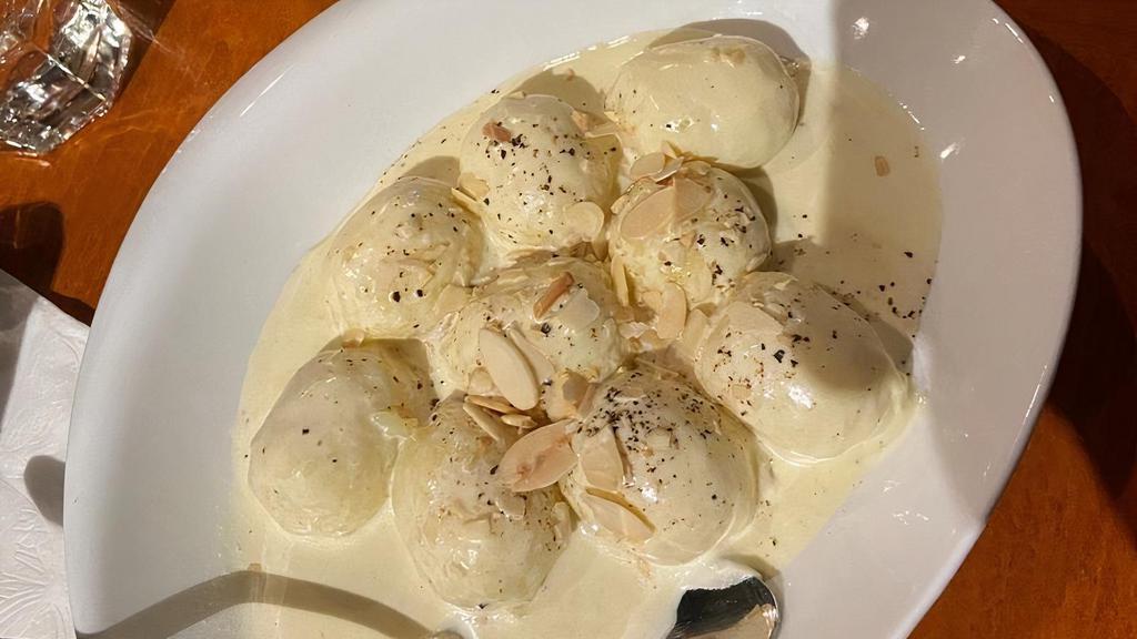 Stuffed Gnocchi Cacio Pepe · Fresh gnocchi stuffed with Pecorino and fresh pepper in a creamy sage sauce topped with toasted almonds.