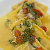 Blue Crab Ravioli · Ravioli stuffed with blue crab, served with a basil butter.