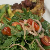 Pork Chop Milanese · 12 oz. thinly pounded breaded pork chop topped with arugula, shallots, and tomatoes in light...