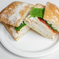 Chicken Pesto · Grilled chicken, fresh mozzarella, roasted red peppers, baby spinach, creamy pesto sauce.