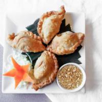 Thai Curry Puff · Pastry puffs, stuffed with minced chicken, onions, potatoes and curry powder.